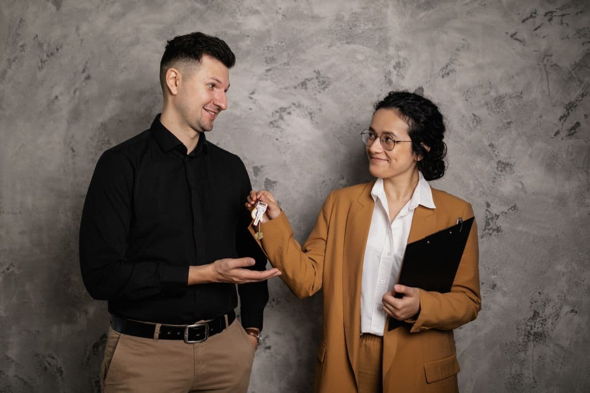 Real estate agent handing over house keys to a client