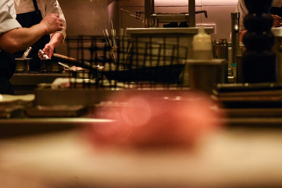 Chefs preparing food in a restaurant kitchen